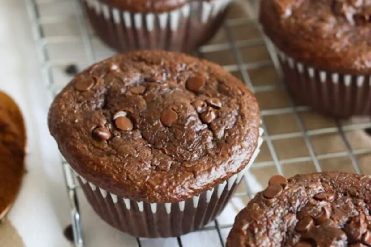 Chocolate Cottage Cheese Muffins with glossy tops and visible melted dark chocolate chips on top
